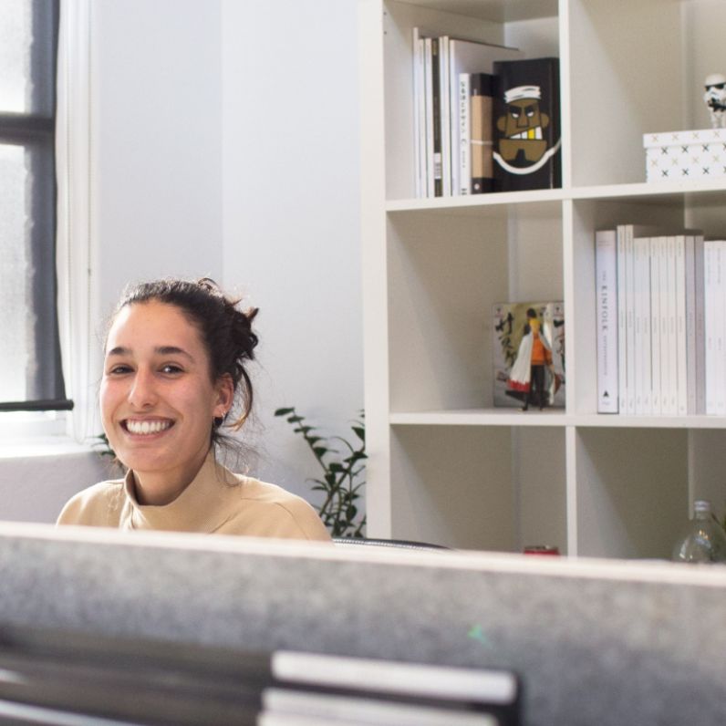 Woman smiling while sitting at desk