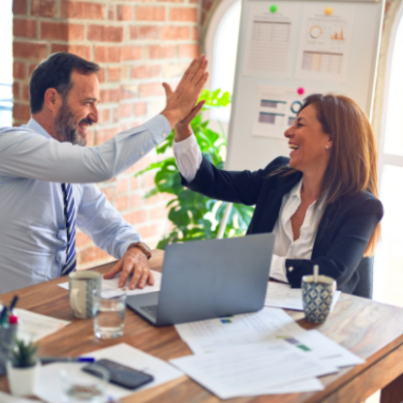 A man and a woman high fiving.