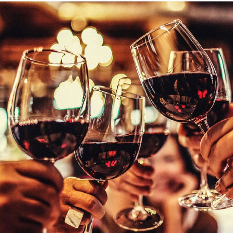 Wine glasses clinking in a toast